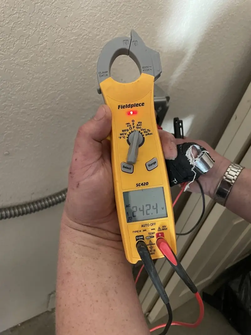 Voltage testing with clamp meter during Electrical Installation Services in Andrews AFB